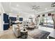 Bright living room with blue kitchen, an open floor plan, and sliding doors to the outdoor area at 6117 Sandy Springs Ct, St Cloud, FL 34771