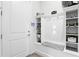 Well-organized mud room with built-in shelves, coat hooks, and a bench for added convenience at 6117 Sandy Springs Ct, St Cloud, FL 34771