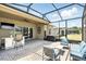 Covered lanai and screened in patio area with bar, and comfortable seating at 6117 Sandy Springs Ct, St Cloud, FL 34771