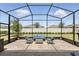 Screened patio area features comfortable seating and lovely outdoor views at 6117 Sandy Springs Ct, St Cloud, FL 34771