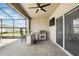 Outdoor patio features a built-in grill, a ceiling fan, and a screened-in enclosure at 6117 Sandy Springs Ct, St Cloud, FL 34771