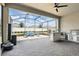 Spacious screened patio with an outdoor kitchen, comfortable seating, and paver flooring at 6117 Sandy Springs Ct, St Cloud, FL 34771