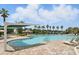 Large community pool with lap lanes and a shaded seating area, surrounded by palm trees at 6117 Sandy Springs Ct, St Cloud, FL 34771