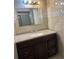 Modern bathroom featuring a granite countertop vanity and decorative tiled walls and large frameless mirror at 6567 Magee Ct, Orlando, FL 32818