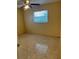 Well-lit bedroom with tile flooring, a window for natural light, and a ceiling fan at 6567 Magee Ct, Orlando, FL 32818