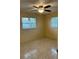 Bedroom featuring tile flooring, two windows and a ceiling fan at 6567 Magee Ct, Orlando, FL 32818