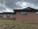 Side view of home's exterior showing brick wall at 6567 Magee Ct, Orlando, FL 32818