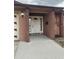 Inviting front entrance with a white door and side windows, complemented by brick and stucco accents at 6567 Magee Ct, Orlando, FL 32818