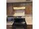 Close up on kitchen with microwave and oven range at 6567 Magee Ct, Orlando, FL 32818