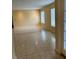 Sunny living room with tiled flooring, neutral walls, and large windows, providing ample natural light at 6567 Magee Ct, Orlando, FL 32818