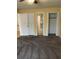 Spacious main bedroom with a view to a tiled bathroom through the doorway and mirrored closet doors at 6567 Magee Ct, Orlando, FL 32818