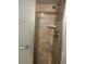 Close-up of shower with tiled walls, a built-in niche, and a shower head with metal hardware at 6567 Magee Ct, Orlando, FL 32818