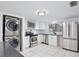 Bright kitchen featuring stainless steel appliances and stacked washer/dryer at 713 Saint Matthew Cir, Altamonte Springs, FL 32714