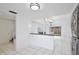 Spacious open-concept living area with tile flooring, desk, and slider doors to backyard at 713 Saint Matthew Cir, Altamonte Springs, FL 32714