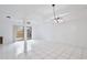 Bright living room featuring white tile floors, ceiling fan, modern lighting, and sliding glass doors at 713 Saint Matthew Cir, Altamonte Springs, FL 32714