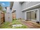 Exterior view of a concrete patio with sliding glass door and a storage shed at 713 Saint Matthew Cir, Altamonte Springs, FL 32714