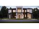 Striking modern two-story home with a dark-wood facade and minimalist landscaping at 7807 Loxahatchee Ct, Reunion, FL 34747
