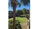 An outdoor view of the property showcases lush tropical landscaping, palm trees and building at 7900 S Orange Blossom Trl # 2052, Orlando, FL 32809