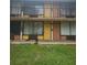 A two-story building featuring exterior walkways and colorful doors to individual units at 7900 S Orange Blossom Trl # 2052, Orlando, FL 32809