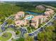 Aerial view of the condo community, showcasing lush landscaping, pool, lake and ample parking at 8763 Worldquest Blvd # 5306, Orlando, FL 32821