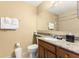 Bathroom featuring a granite vanity top, a sink, and a toilet at 8763 Worldquest Blvd # 5306, Orlando, FL 32821