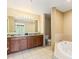 Spacious bathroom with double sink vanity, soaking tub, and separate toilet area at 8763 Worldquest Blvd # 5306, Orlando, FL 32821