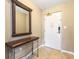 Welcoming condo entryway with a decorative mirror, console table, and tile flooring at 8763 Worldquest Blvd # 5306, Orlando, FL 32821