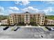 Multi-story condo building featuring balconies, ample parking, and well-maintained landscaping at 8763 Worldquest Blvd # 5306, Orlando, FL 32821