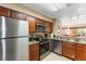 Modern kitchen with stainless steel appliances, tile floors, and an open layout at 8763 Worldquest Blvd # 5306, Orlando, FL 32821