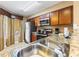 Well-equipped kitchen with modern appliances and granite countertops, including sink and faucet at 8763 Worldquest Blvd # 5306, Orlando, FL 32821