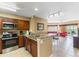 Open kitchen featuring stainless steel appliances and granite countertops, dining area at 8763 Worldquest Blvd # 5306, Orlando, FL 32821