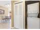 Laundry closet with stacked washer and dryer, conveniently located near the dining area at 8763 Worldquest Blvd # 5306, Orlando, FL 32821