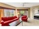 Inviting living room featuring comfortable red furnishings and views of the outdoors at 8763 Worldquest Blvd # 5306, Orlando, FL 32821