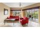 Comfortable living room with large windows and sliding glass door to the outside balcony at 8763 Worldquest Blvd # 5306, Orlando, FL 32821