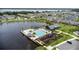 An aerial view of community amenities including a pool, playground, and community center on a lakefront at 889 Terrapin Dr, Debary, FL 32713