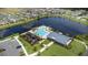 Aerial view featuring a community pool, playground, parking area, and community center by a lake at 889 Terrapin Dr, Debary, FL 32713