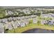 Expansive aerial view of a residential community featuring well-maintained homes and green spaces, next to a pond at 889 Terrapin Dr, Debary, FL 32713