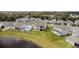 Aerial view of homes with manicured lawns, a pond, and a lush tree line at 889 Terrapin Dr, Debary, FL 32713