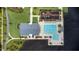Overhead shot of a community pool and playground next to the lake, accented by palm trees and seating areas at 889 Terrapin Dr, Debary, FL 32713
