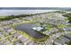 An aerial view showcases a community with a central lake, a pool, and playgrounds, surrounded by residential homes at 889 Terrapin Dr, Debary, FL 32713