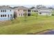 Back view of the home with an outdoor lanai, balcony, backyard, and pond at 889 Terrapin Dr, Debary, FL 32713