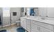 Bright bathroom with a double vanity, tile floors, toilet, and walk-in shower at 889 Terrapin Dr, Debary, FL 32713
