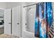 Bright bathroom features a tub/shower combo with a unique galaxy-themed shower curtain at 889 Terrapin Dr, Debary, FL 32713