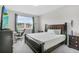 Spacious bedroom featuring a queen bed, gray carpet, and large window at 889 Terrapin Dr, Debary, FL 32713