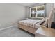 Bright bedroom with a bed, window, and neutral gray walls and carpet at 889 Terrapin Dr, Debary, FL 32713