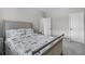 Neutral bedroom with patterned bedding, two white doors, and gray walls and carpet at 889 Terrapin Dr, Debary, FL 32713