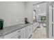 Charming butler's pantry featuring granite countertops, white cabinetry, and views of the dining area at 889 Terrapin Dr, Debary, FL 32713