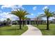 A modern community center surrounded by palm trees and a well-manicured lawn under a blue sky at 889 Terrapin Dr, Debary, FL 32713