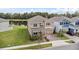 Exterior elevation of a two-story home showcasing manicured landscaping, a paved driveway, and a two-car garage at 889 Terrapin Dr, Debary, FL 32713