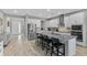 Bright kitchen featuring granite countertops, white cabinets, stainless steel appliances, and a large island with seating at 889 Terrapin Dr, Debary, FL 32713